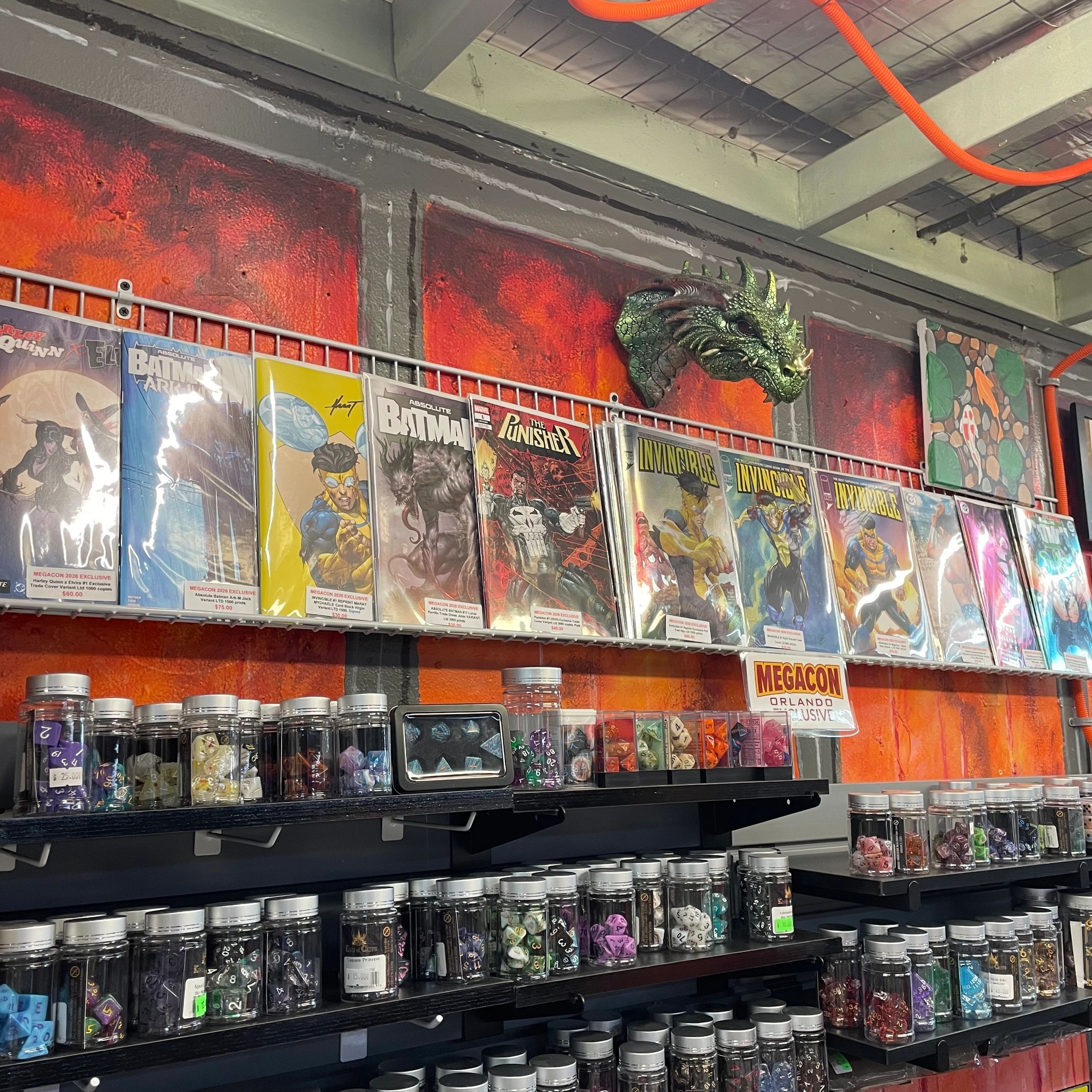 Comic books and jars of dice displayed in a game shop