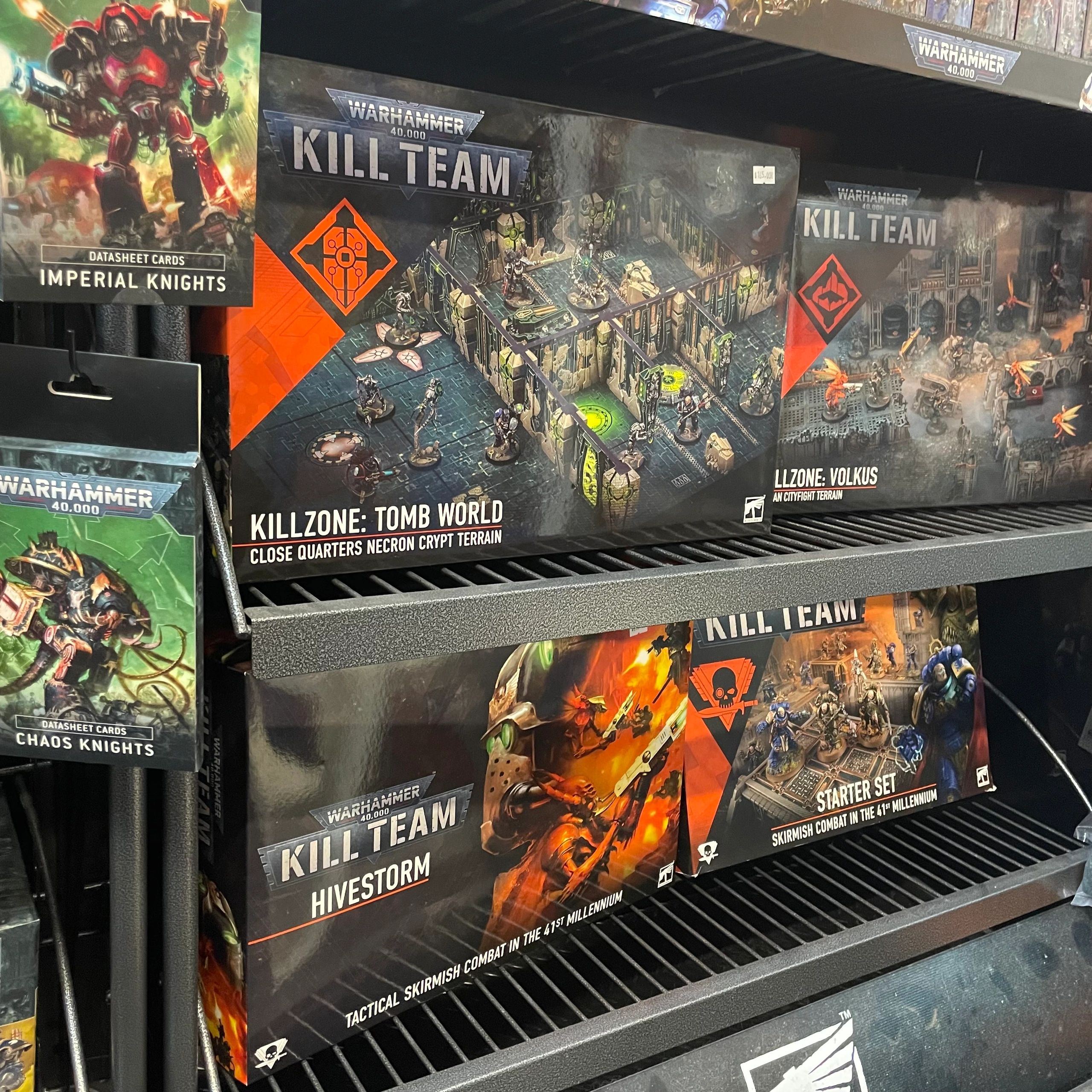 Warhammer Kill Team boxed sets on store shelves with datasheet cards