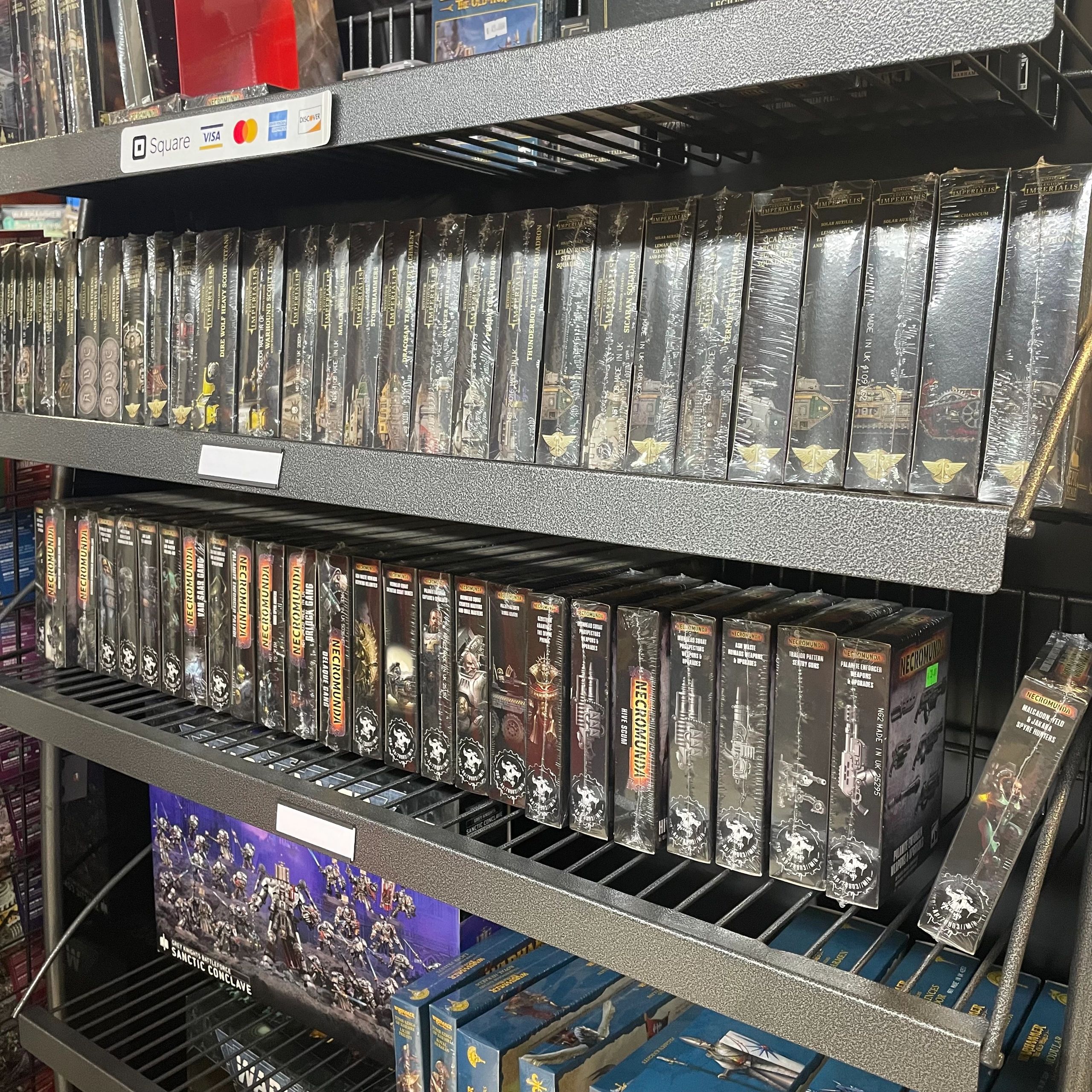 Shelves filled with boxed Warhammer 40k miniatures and expansions