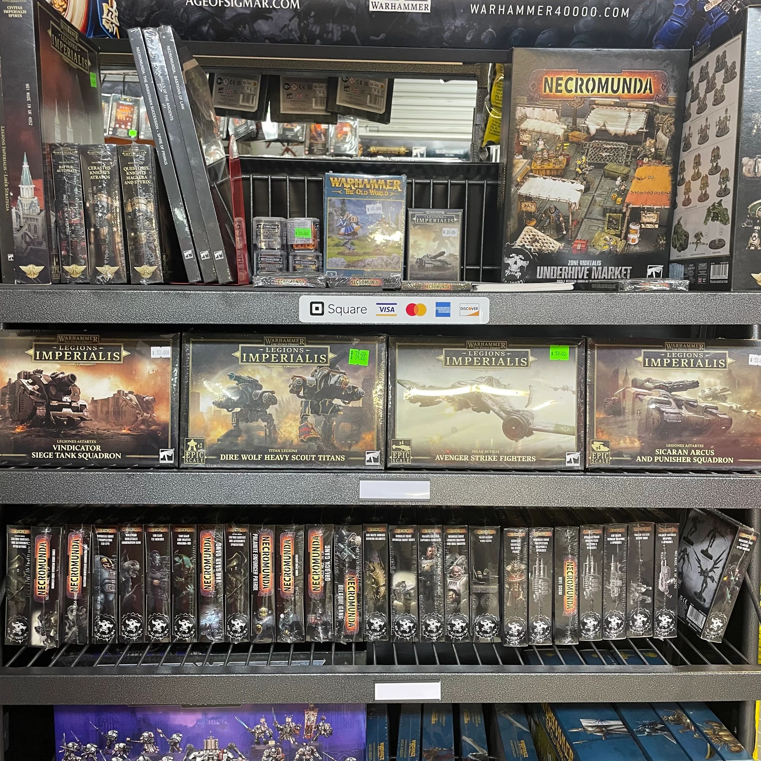 Shelves filled with Warhammer 40,000 and Necromunda model kits and accessories