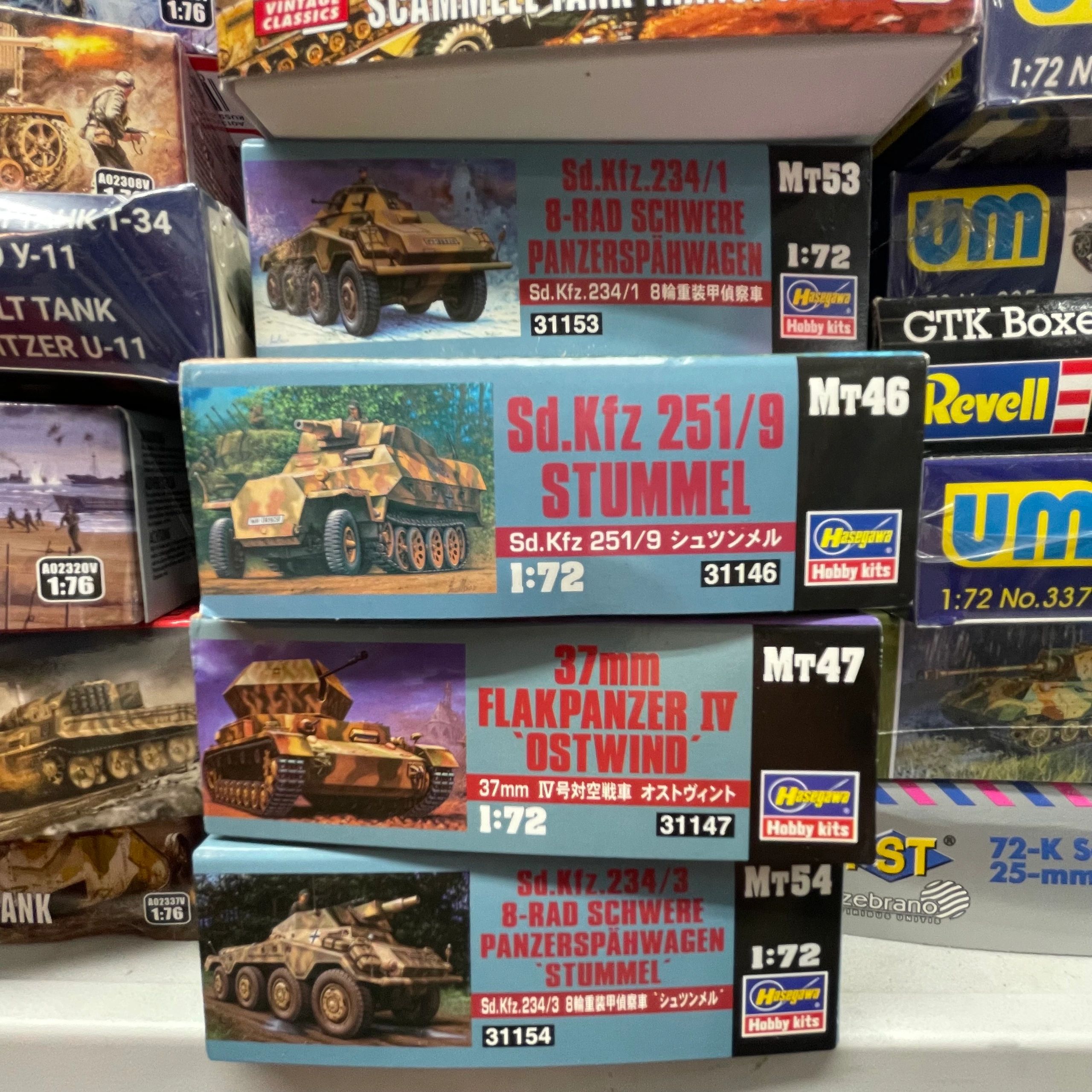 Stack of military vehicle model kits from Hasegawa in 1:72 scale