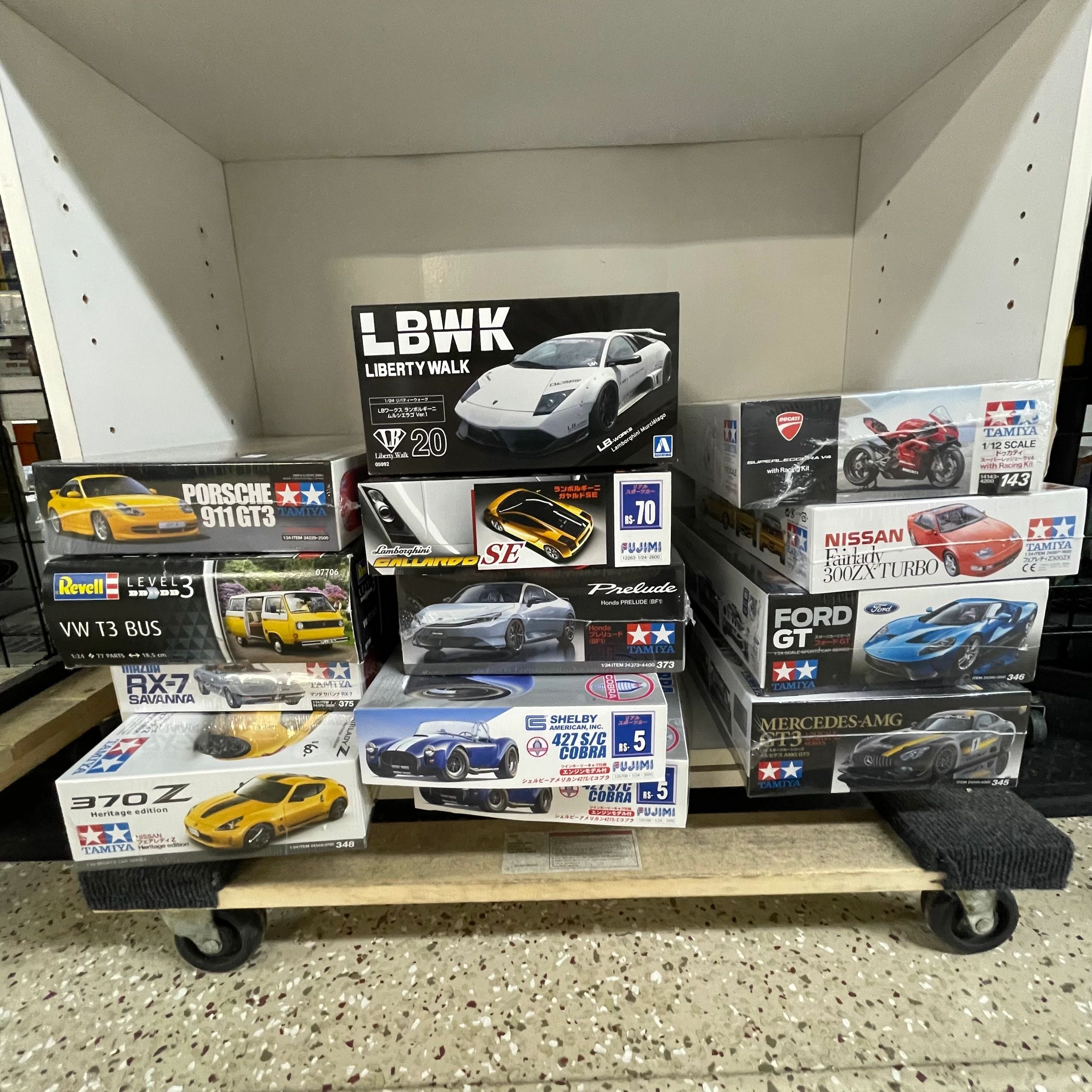Tamiya model kit boxes on shelves