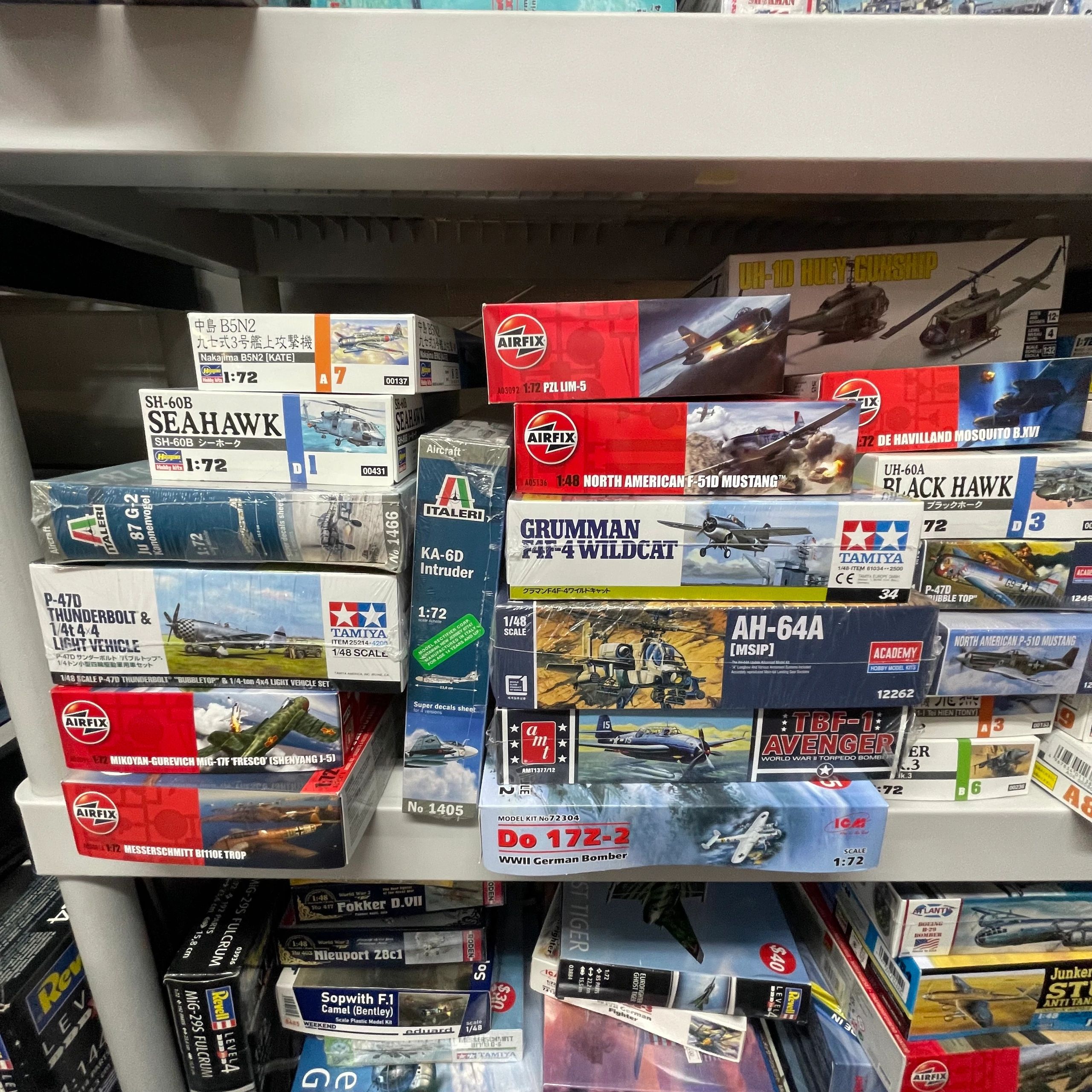 A collection of model airplane kits stacked on shelves