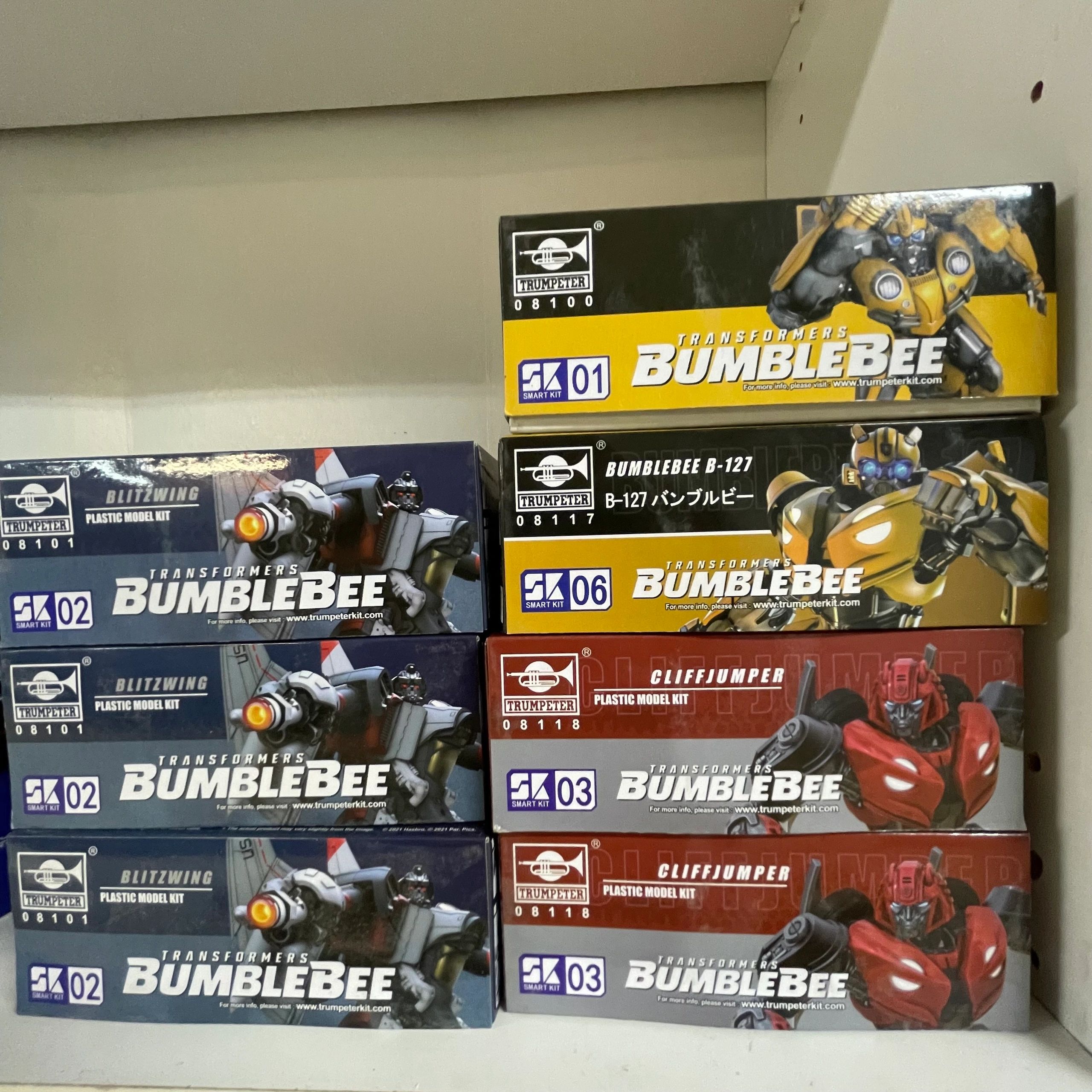 Stack of Transformers Bumblebee model kits featuring Blitzwing, Bumblebee, and Cliffjumper