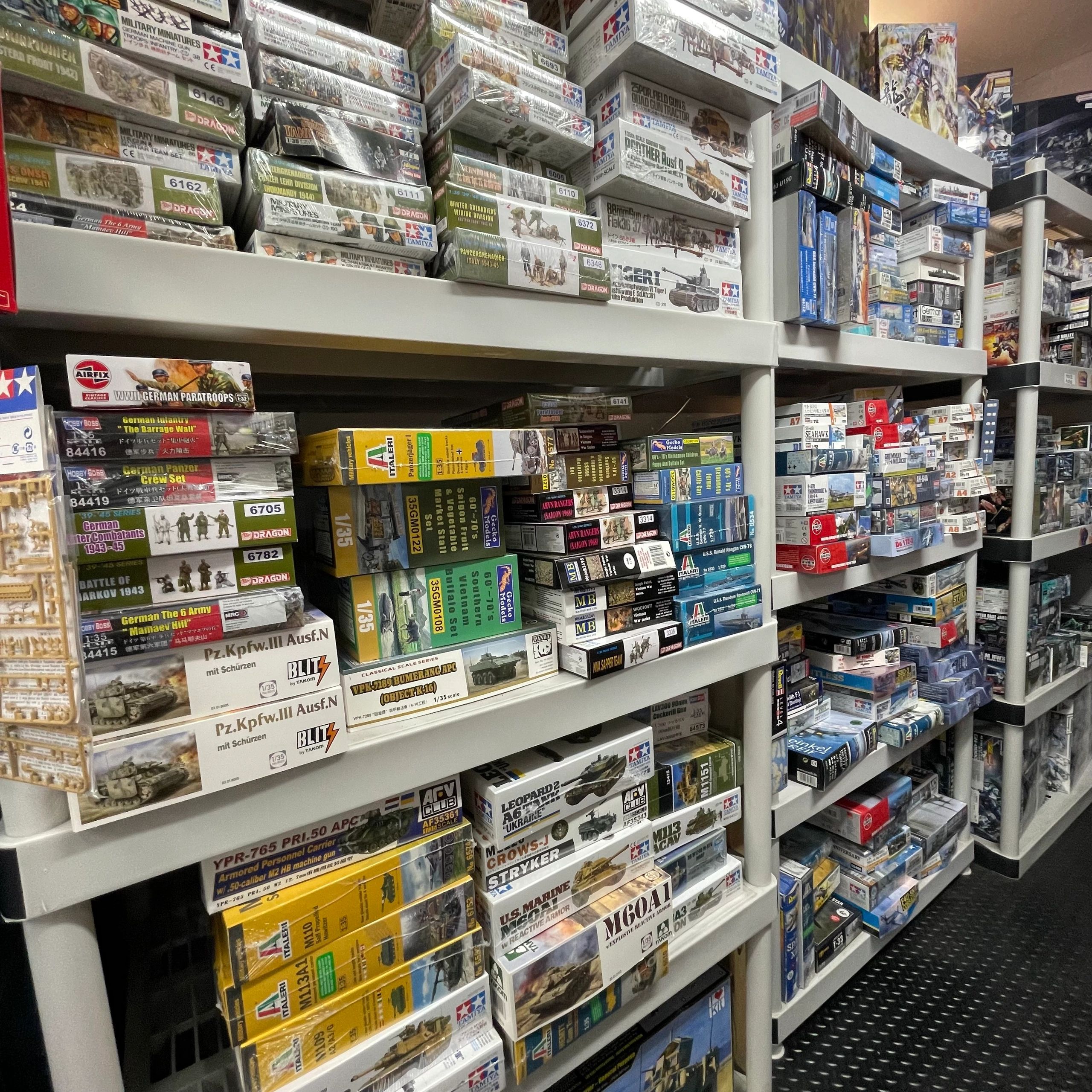 Shelves filled with model kits of military vehicles and figures
