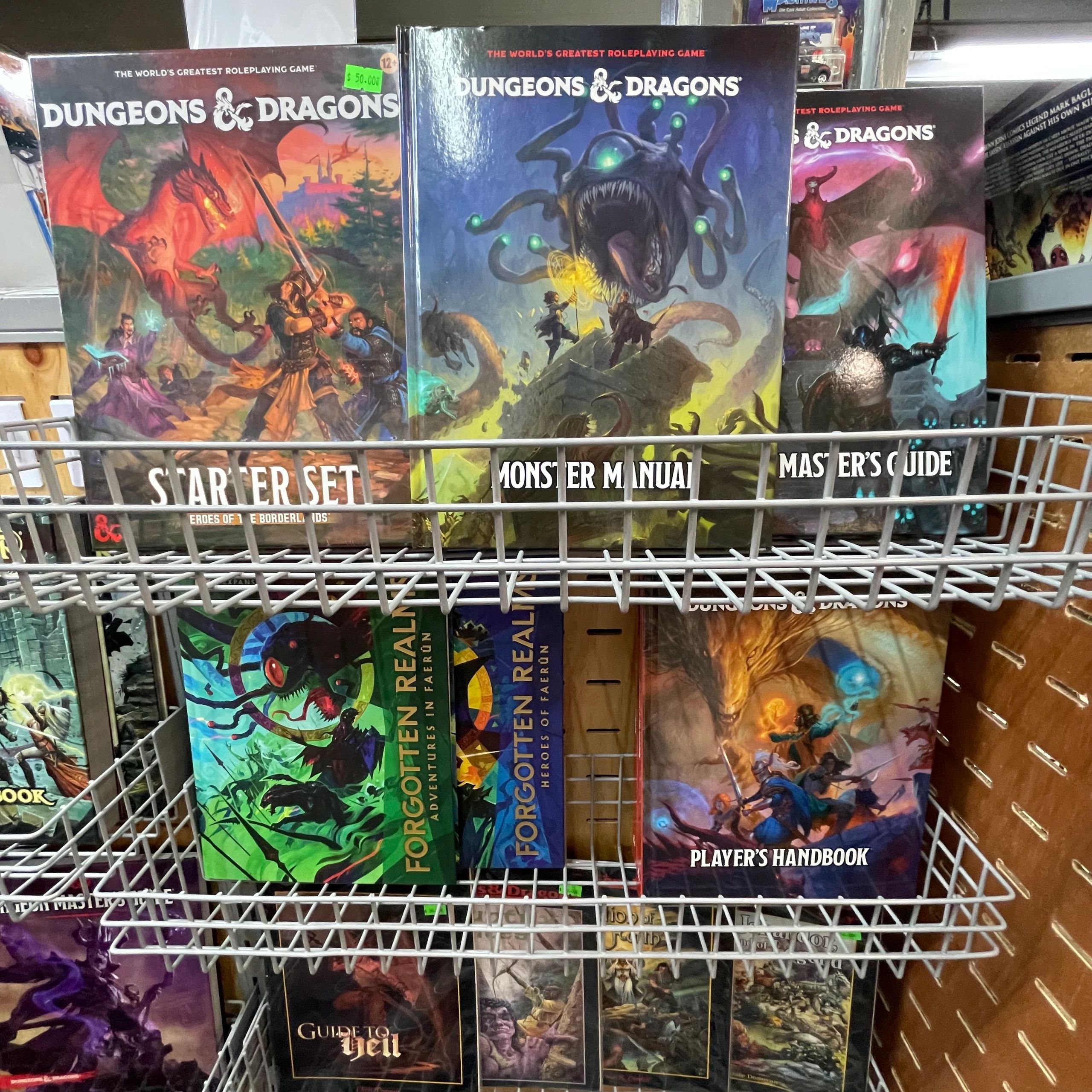 A display of Dungeons and Dragons books including Starter Set, Monster Manual, and Player's Handbook