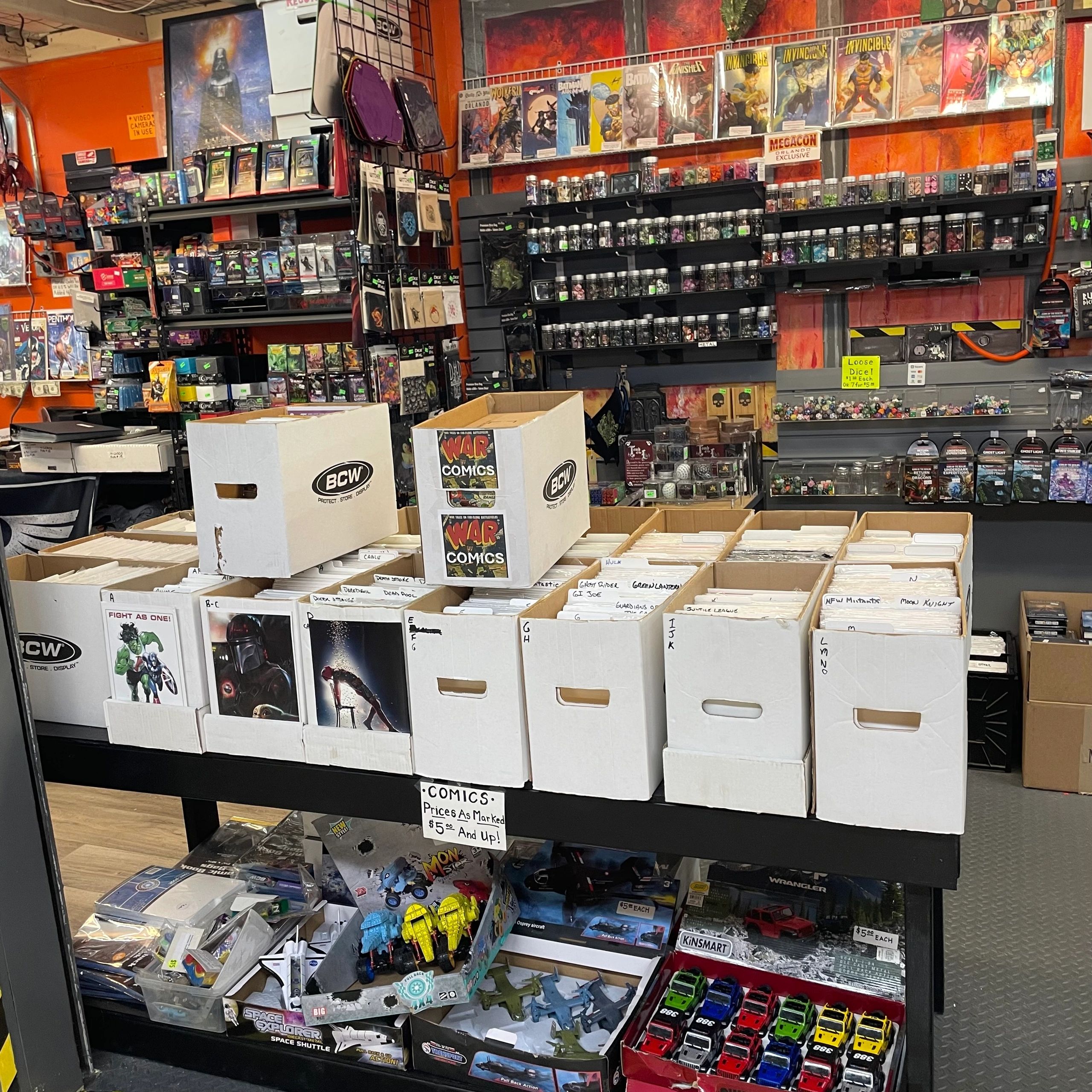 Comic book store with boxes of comics and collectible toys on display